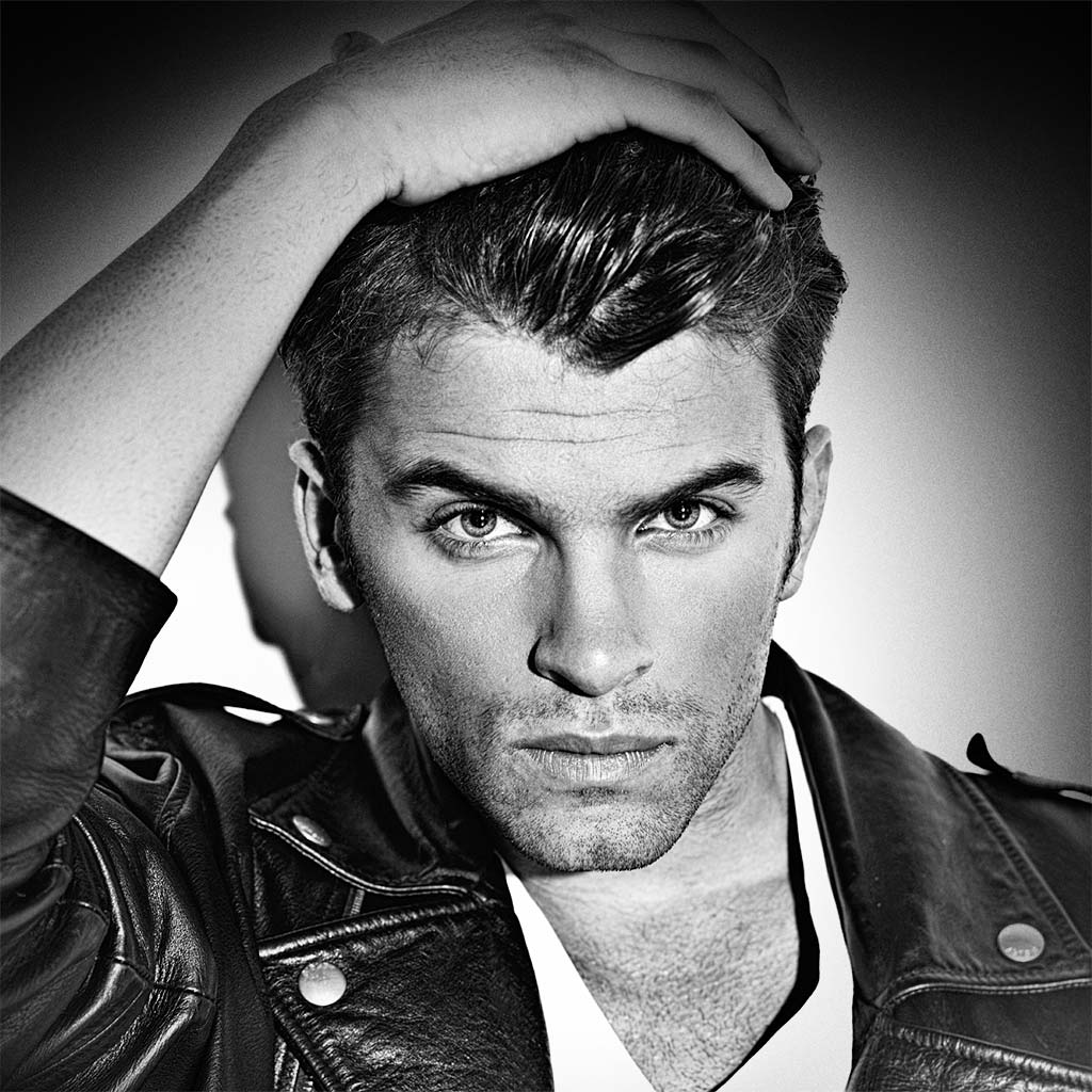 Cool Male model with hair styled with MOJO Classic Pomade showing sleek low shine- now perfect your style with Mojo Hair* Classic Pomade